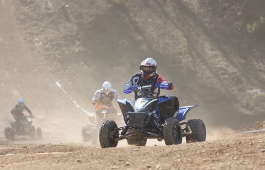 MOHELNICE,  CZECH REPUBLIC - APRIL 16, 2022: Group of riders on a quad bike in turn in International Championship of Czech Republic in Sidecarcross, category Quad on April 16, 2022 in Mohelnice.