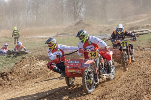 MOHELNICE, CZECH REPUBLIC - APRIL 16, 2022. Group of racers ride a sidecar in the "Sidecarcross Championship of Czech Republic"" on April 16, 2022 in the town of Mohelnice, Czech Republic."