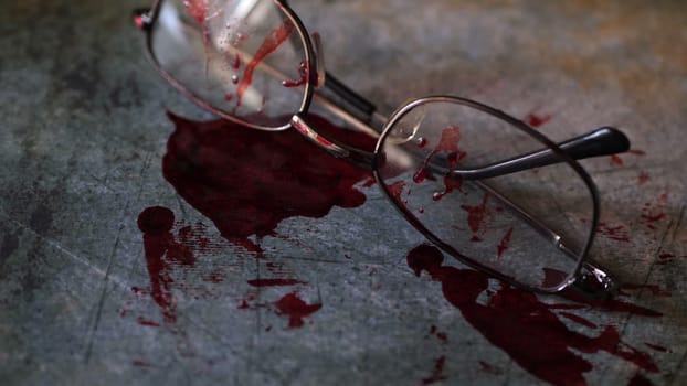 Grungy conceptual crime scene with blood and glasses.