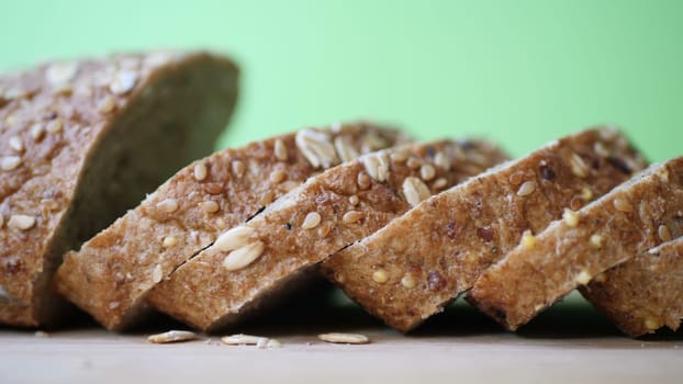Slicing Whole Grain Bread On Wooden Table.