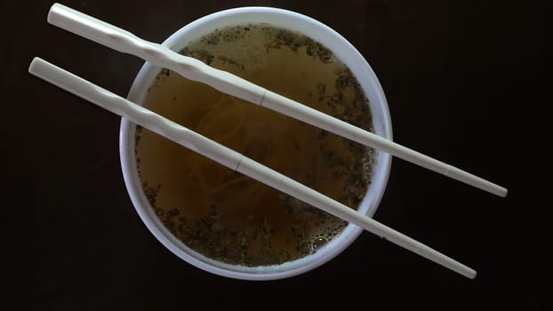 Close up of instant noodles yellow ramen and  Chinese chopsticks,Close up of instant noodles yellow ramen and  Chinese chopsticks