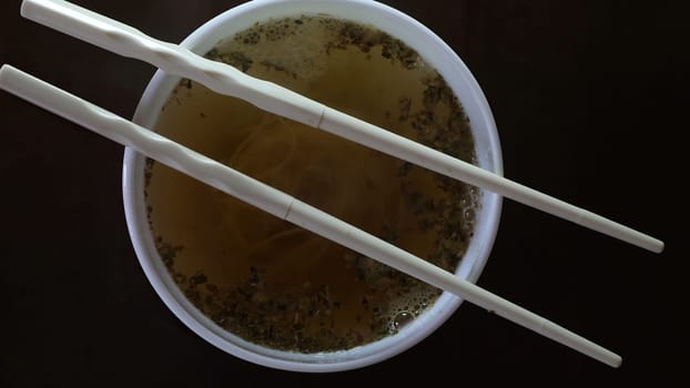 Close up of instant noodles yellow ramen and  Chinese chopsticks,Close up of instant noodles yellow ramen and  Chinese chopsticks