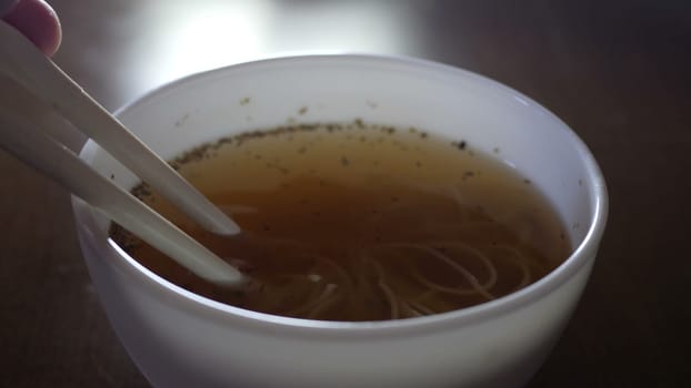 Close up of instant noodles yellow ramen and  Chinese chopsticks