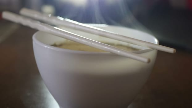 Close up of instant noodles yellow ramen and Chinese chopsticks