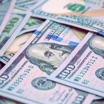 A hundred American banknotes are scattered. cash hundred-dollar bills, dollar background image.