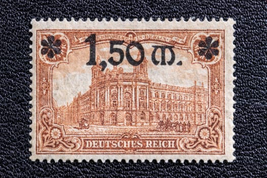 Potsdam, Germany – APR 20, 2022. Stamp year 1920 of the German Reichspost. Representative Figures of the German Empire, Reichspostamt Berlin with new value grade 1.50 Mark, issue date from June 1920. Macro.