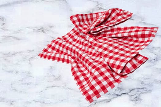 Empty table product. Top view of a abstract blurred marble top with a red and white checkered tablecloth or napkin. Template for your food and product display montage. Space for food recipe.