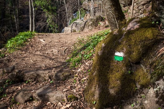 Nogaleas ravine track painted sign on rock. Navaconcejo, Extremadura, Spain