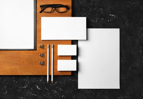 Blank business stationery set. Corporate identity template and wooden board. Flat lay.