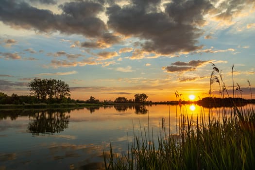 Beautiful sunset over a calm lake, summer day, Stankow, Poland