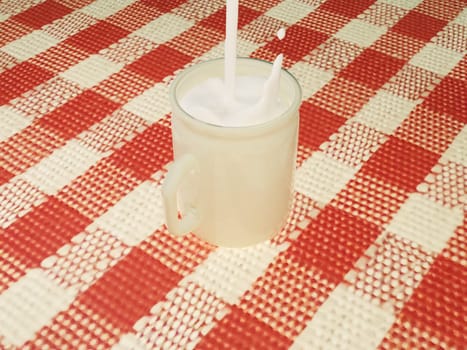 Milk pouring in a cup, 3d rendering