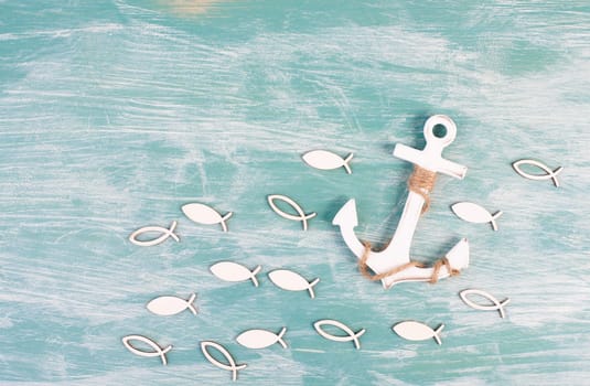 White anchor and fish on a blue background, maritime sea life, sailing trip, summer vacation, tourism concept, harbor