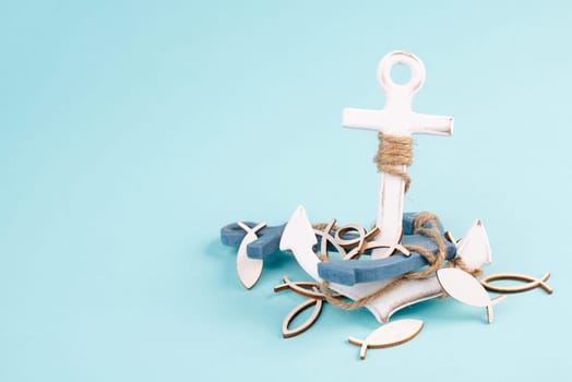White anchor and fish on a blue background, maritime sea life, sailing trip, summer vacation, tourism concept, harbor
