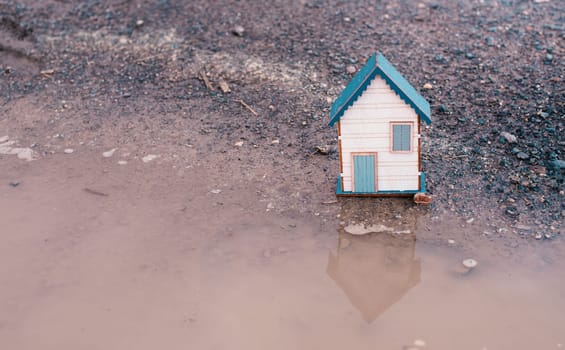 Small house standing on a road, real estate concept, renting or buying a home, travel and vacation symbol