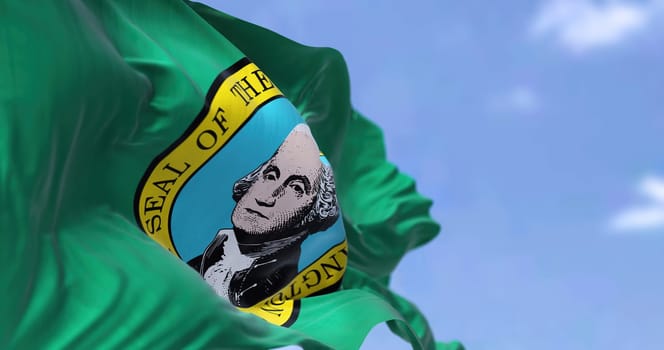 The US state flag of Washington waving in the wind. Washington is a state in the Pacific Northwest region of the Western United States. Democracy and independence.