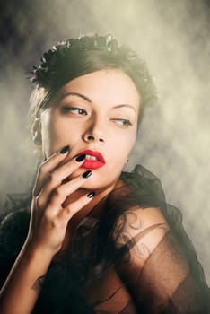 Beautiful young woman with elegant makeup in front of night lights.