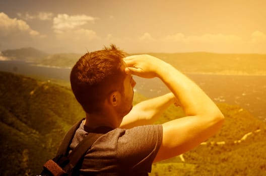 Backpack traveler enjouing the nature and looking at horizone