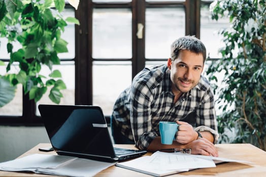 Young man working in cool workspace. Modern office concept.