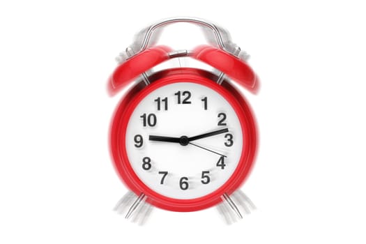 A ringing alarm clock. Red retro alarm clock on white with ringing effect