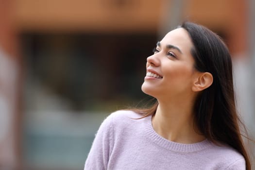 Happy woman looking at side in the street
