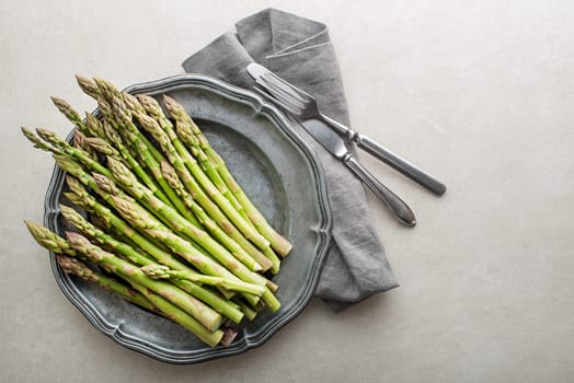 Fresh of green Asparagus in plate. Cooking healthy meal. Bunches of green asparagus, top view- Image