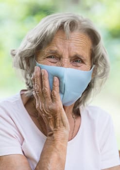 Elderly woman wearing a protective face mask against corona virus