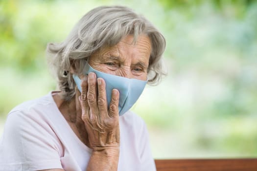 Elderly woman wearing a protective face mask against corona virus