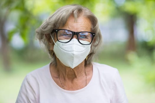 Elderly woman wearing a protective face mask against corona virus