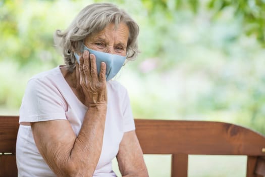 Elderly woman wearing a protective face mask against corona virus