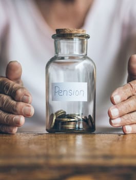 Elderly retired woman and her savings in a jar