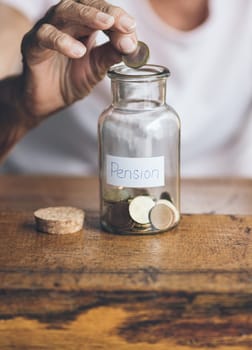 Elderly retired woman and her savings in a jar