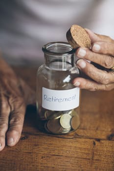 Elderly retired woman and her savings in a jar
