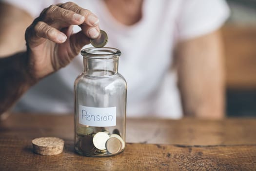 Elderly retired woman and her savings in a jar