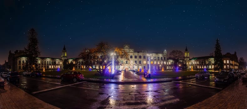 Panoravic night view of main building of Igor Sikorsky Kyiv Polytechnic Institute KPI under the night sky. Kyiv, Ukraine