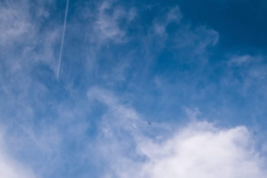 Little white plane on a background of the blue summer sky.