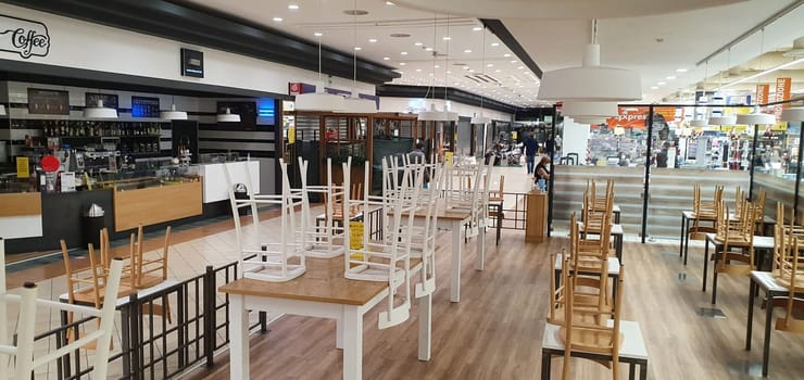 empty food and restaurant client-side area with chairs upside-down for quarantine and lockdown in COVID-19 times