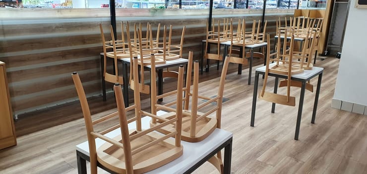 empty food and restaurant client-side area with chairs upside-down for quarantine and lockdown in COVID-19 times