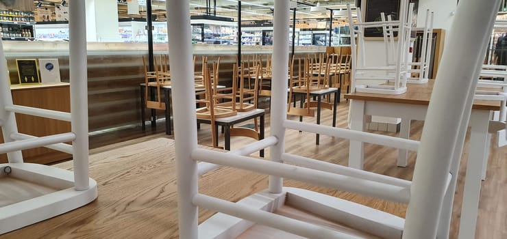 empty food and restaurant client-side area with chairs upside-down for quarantine and lockdown in COVID-19 times