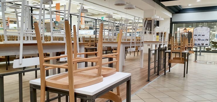 empty food and restaurant client-side area with chairs upside-down for quarantine and lockdown in COVID-19 times