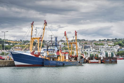 Large fishing boats moored in Howth harbour. Phishing and shellfish fishing equipment on fishing boats, Dublin, Ireland