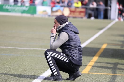 Somewhat thoughtfully,coach Nurhan Ardiclik (SV Hinterzarten) crouches on the sidelines at the game of the football KL A Black Forest - 21st season 21-22 - SV Hinterzarten vs SV Öfingen