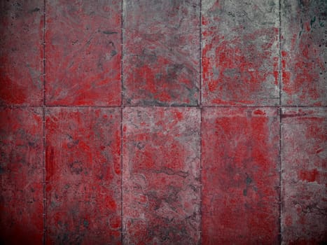 Old damaged metal plate wall that was once painted red.