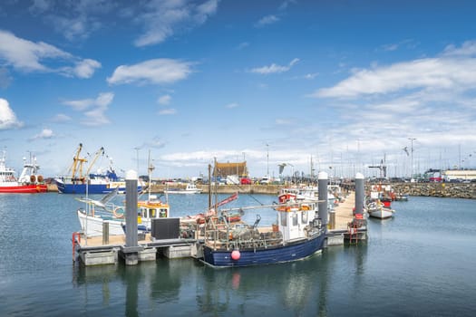 Small fishing boats moored in Howth harbour. Phishing and shellfish fishing equipment on fishing boats, Dublin, Ireland