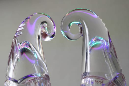 Crystal figures on a gray background in neon light..