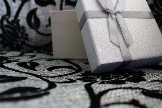 Silver wrapping from the gift on a gray-black background..