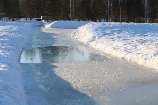A snowy road in the spring. Melting snow. Puddles. High quality photo
