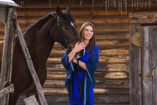 Happy girl hugging a horse and looking into the distance