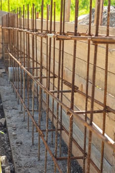 Construction of a strip foundation, reinforcement strapping, formwork in the background