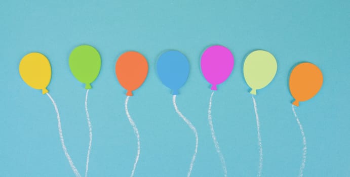 Colorful ballons on a blue colored background, children birthday greeting card, happy holiday, copy space for text