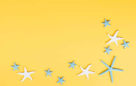 Yellow colored summer and vacation background, anchor and sea stars building a frame, copy space for text, holiday and tourism concept